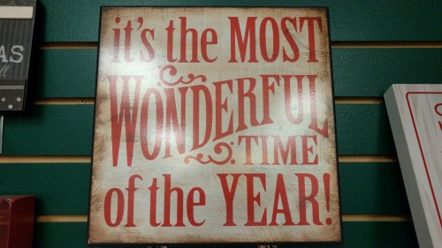 Sign with festive text: "It's the MOST WONDERFUL Time of the YEAR!" in bold red letters on a light background.