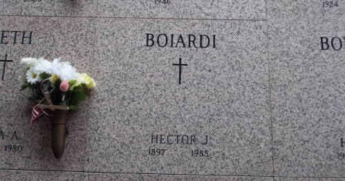 Gravestone with the name "Boiardi" and "Hector J. 1897-1985," adorned with flowers.