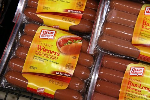 Packaged Oscar Mayer Classic Wieners, featuring hot dogs made with chicken, turkey, and pork, displayed in a store.