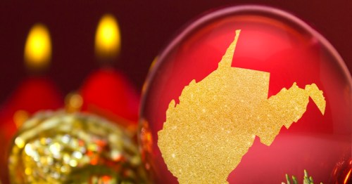 A festive ornament featuring a gold silhouette of West Virginia against a red background with blurred lights.