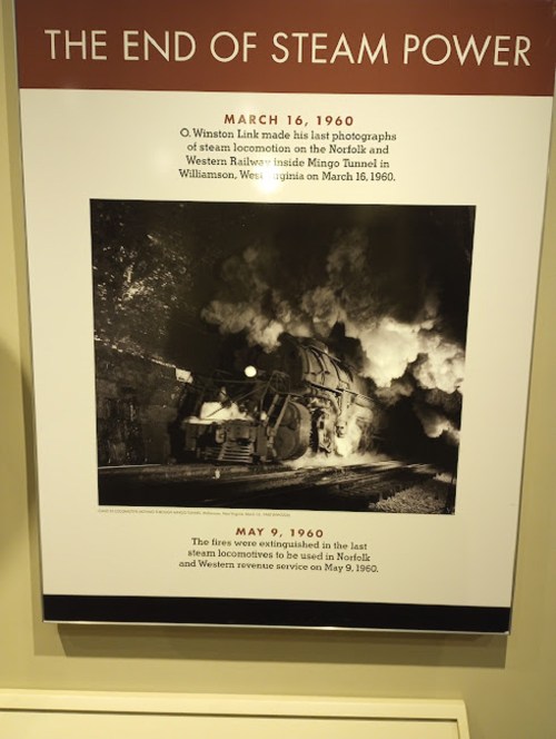 Historic display about the end of steam power, featuring a photo of a steam locomotive in a tunnel, with dates and details.