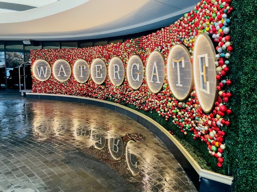 A vibrant wall display at the Watergate, adorned with colorful ornaments and illuminated signage.