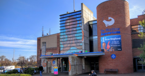 Exterior view of the Maritime Aquarium, featuring a modern design and colorful signage.