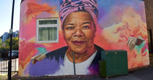 Closeup of a vibrant painting of Maya Angelou on a building in London