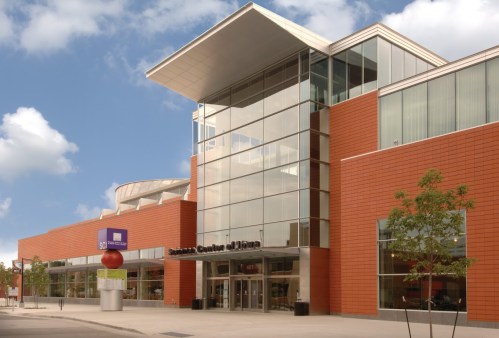 Modern building with large glass windows and a distinctive roof, featuring signage for the Science Center of Iowa.