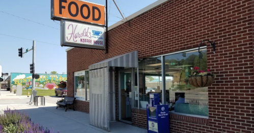 Exterior of Harold's Coffee House with a sign reading "FOOD," featuring a brick facade and large windows.