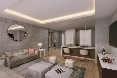 Modern hotel suite featuring a cozy seating area, bar counter, and elegant decor with soft lighting.