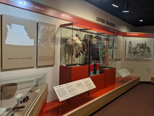 Exhibit showcasing Native American artifacts, maps, and historical information about Indian Country and cultural traditions.