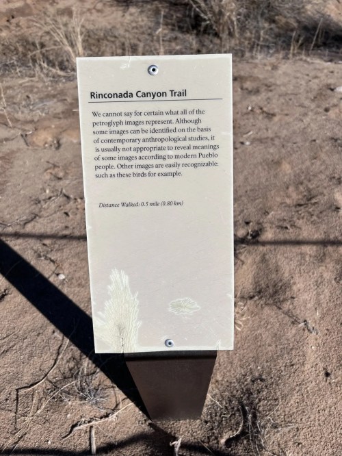 Sign for Rinconada Canyon Trail discussing petroglyph images and their meanings, with a distance of 0.5 miles noted.