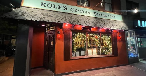 Exterior of Rolf's German Restaurant, featuring festive lights and a warm, inviting atmosphere at night.