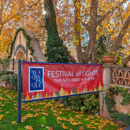 A colorful banner for the "Festival of Lights" event at Tlaquepaque, with autumn leaves and trees in the background.