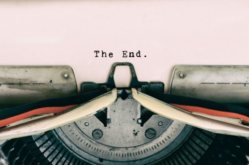 Close-up of a typewriter with the words "The End." typed on a sheet of paper.