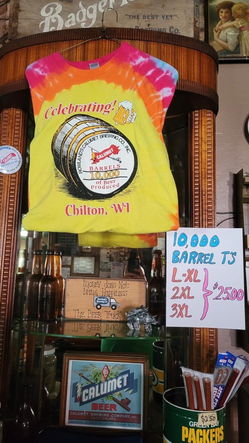 A colorful tie-dye shirt celebrating 10,000 barrels from Calumet Brewing Co., displayed with pricing information.