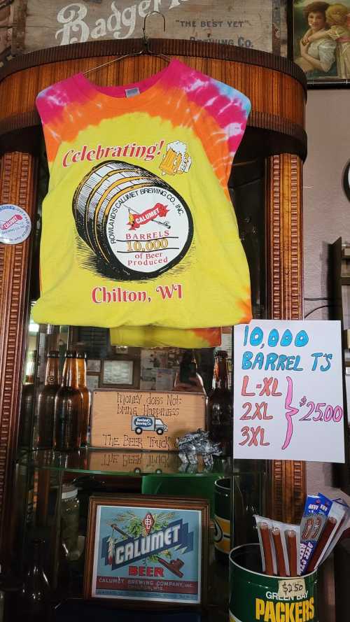 A colorful tie-dye shirt celebrating 10,000 barrels from Calumet Brewing Co., displayed with pricing information.