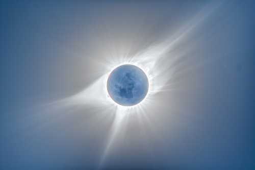 A stunning view of a solar eclipse, with the sun's corona radiating around the darkened moon.