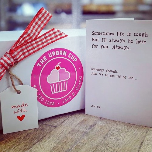 A gift box with a cupcake logo and a card that reads a supportive message about always being there for someone.