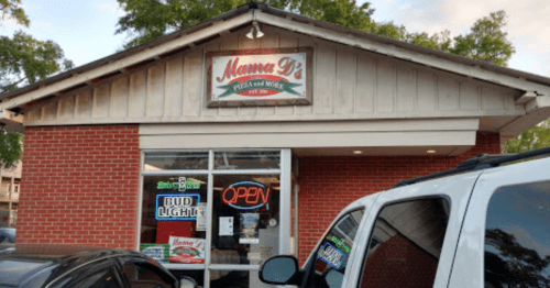 Exterior of Mama D's Pizza & More, featuring a brick facade and an "OPEN" sign in the window.