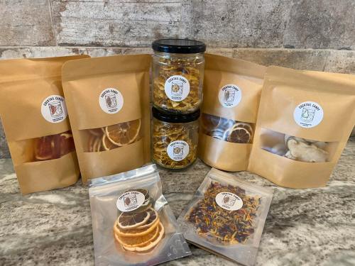 A collection of packaged herbal products, including jars and bags, displayed on a countertop.