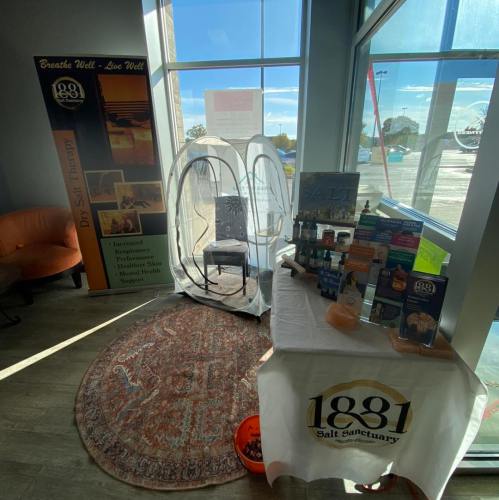 A cozy salt therapy room with a chair, surrounded by promotional materials and a welcoming atmosphere.
