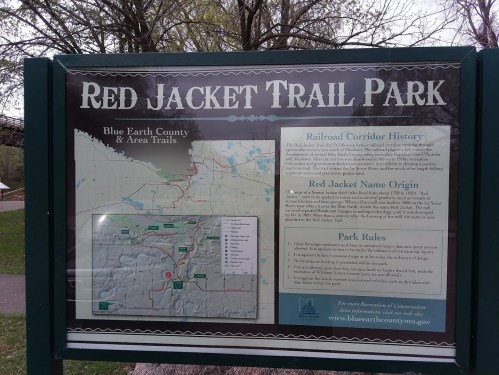 Sign for Red Jacket Trail Park featuring a map and information about the park's history and rules.