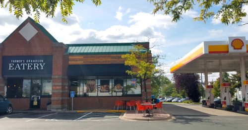 A restaurant named "Farmer's Grandson Eatery" next to a Shell gas station, with outdoor seating visible.
