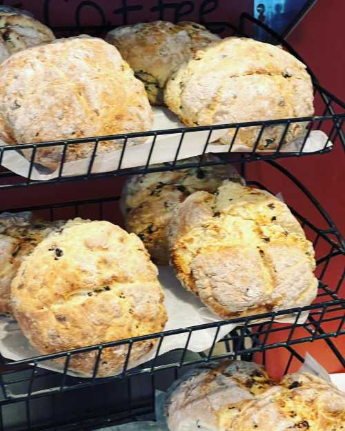 Freshly baked scones on a wire rack, with a warm, golden crust and a variety of textures.