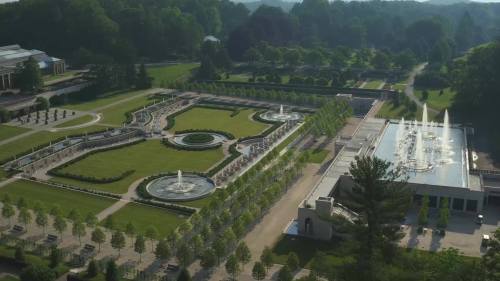 Aerial view of a landscaped garden featuring fountains, pathways, and neatly arranged greenery.