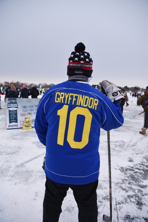 A person wearing a blue hockey jersey with "GRYFFINDOR" and the number 10, standing on an ice rink.