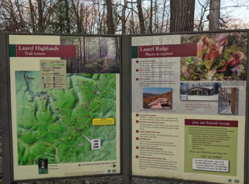 Signboard displaying a map of the Laurel Highlands trail system and information about Laurel Ridge attractions.