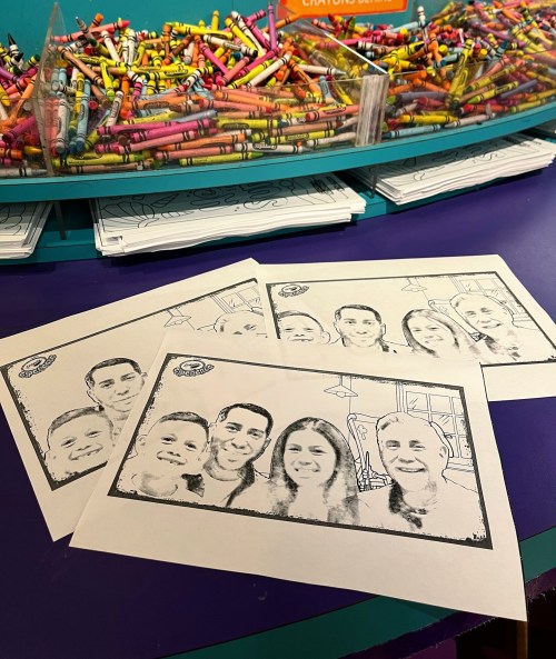 Four black-and-white outline drawings of people on paper, with a colorful pile of crayons in the background.