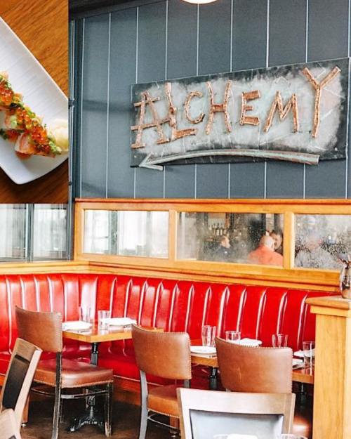 Interior of a restaurant named "Alchemy," featuring a sushi dish and cozy red booths.