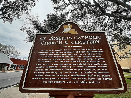 Sign for St. Joseph's Catholic Church and Cemetery, detailing its history and significance in Rayne, Louisiana.