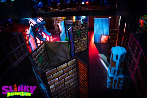 A colorful indoor play area with maze-like structures and vibrant lighting, designed for fun and exploration.