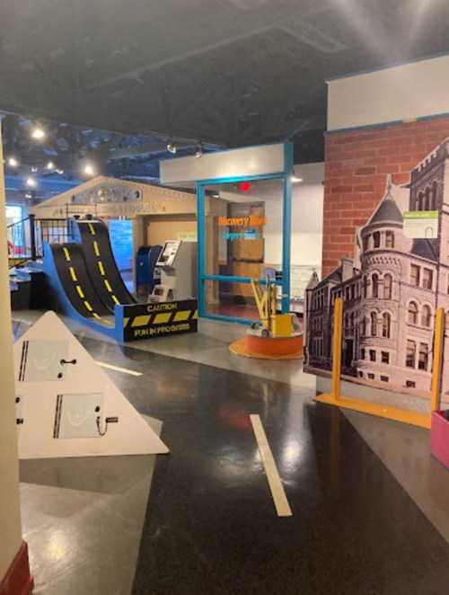 Indoor play area featuring ramps, signs, and colorful displays for children's exploration and fun.