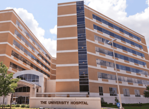 A modern multi-story hospital building with large windows and a welcoming entrance.