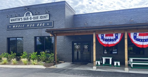 Exterior of Martin's Bar-B-Que Joint featuring a sign, patriotic bunting, and a welcoming entrance.