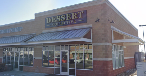 Exterior of a building featuring a sign for "Dessert Collective" with large windows and a clear blue sky.