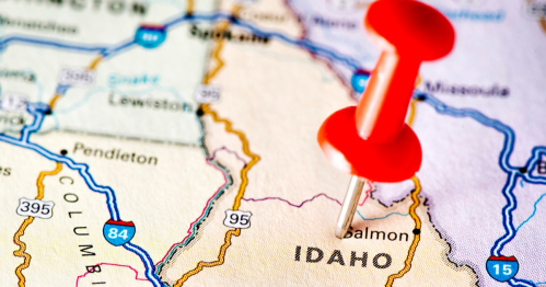 A close-up of a map highlighting Idaho, with a red pushpin marking a specific location.