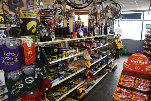 A store display filled with sports merchandise, including apparel, mugs, and decorations for various teams.
