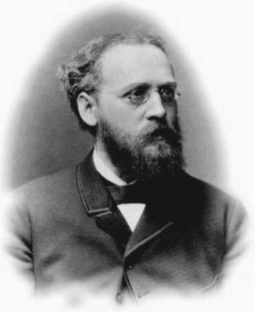 Black and white portrait of a man with glasses, a beard, and wearing a suit, looking thoughtfully to the side.