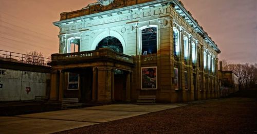 Historic building illuminated at night, showcasing architectural details against a dark sky.