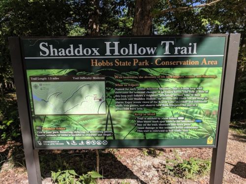 Sign for Shaddox Hollow Trail at Hobbs State Park, detailing trail length, difficulty, and what to expect.