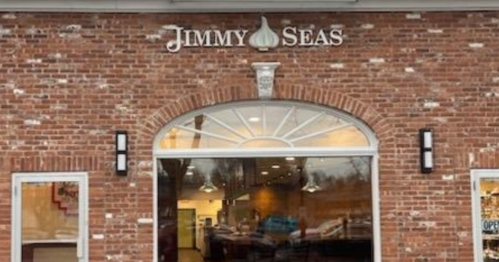Exterior of Jimmy Seas restaurant, featuring a brick facade and large arched window. Sign above reads "JIMMY SEAS."