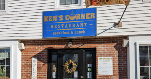 Sign for Ken's Corner Restaurant, featuring "Breakfast & Lunch," with a welcoming entrance and brick facade.