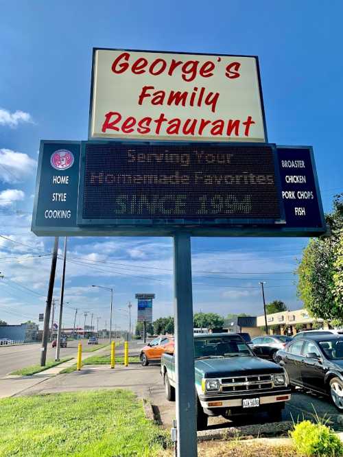 Sign for George's Family Restaurant, featuring "Serving Your Homemade Favorites Since 1984" and menu items like chicken and fish.