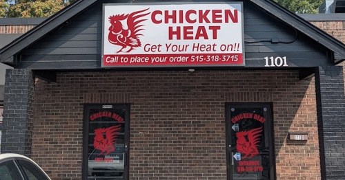 Sign for "Chicken Heat" restaurant with a red logo, featuring contact information and a call to place orders.