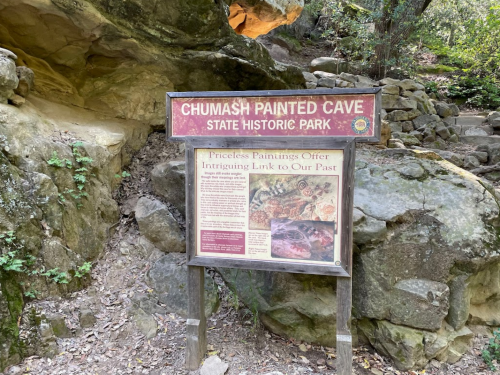 Sign for Chumash Painted Cave State Historic Park, featuring information about its historical significance and artwork.