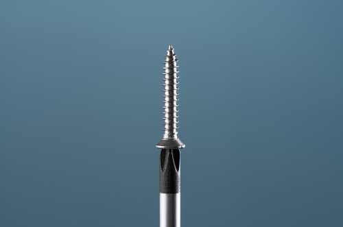 Close-up of a metal screw with a sharp tip and threaded shaft against a gradient blue background.