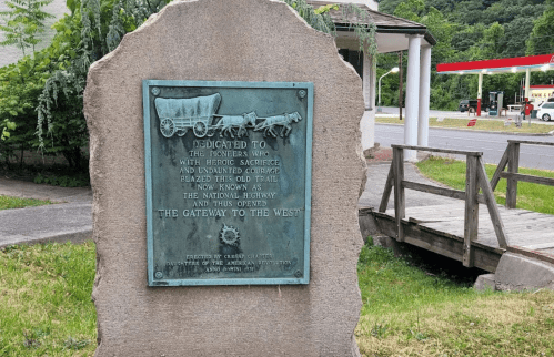 A stone plaque honoring pioneers for their sacrifices, marking the National Highway as "The Gateway to the West."