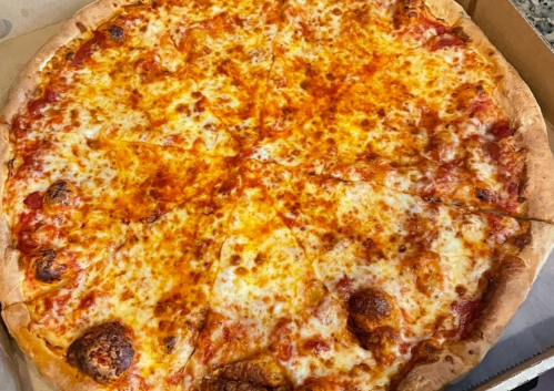 A large cheese pizza with a golden crust, evenly sliced, and topped with melted cheese and tomato sauce.